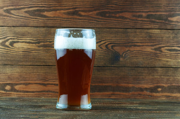 glass of beer on a wooden background
