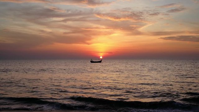 Indian fIshing boat in the sea at sunset 