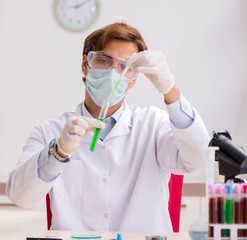 Young chemist working in the lab