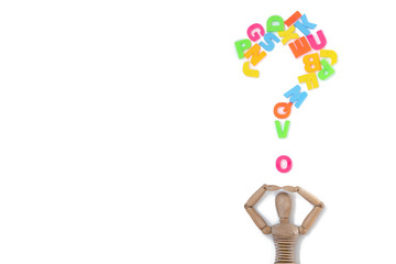 Multicolored letters of the English alphabet in the form of a question and a puppet doll isolated on a white background.