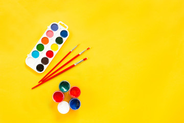 layout with place for school supplies, paint on a yellow isolated background, theme back to school...