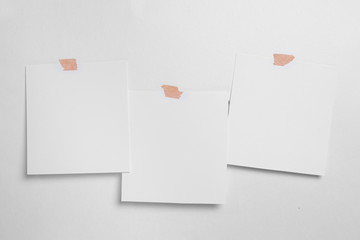 Blank polaroid photo frame with soft shadows and scotch tape isolated on white paper background as template for graphic designers presentations, portfolios etc.