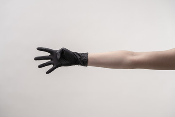Hands in black silicone gloves on a light background.
