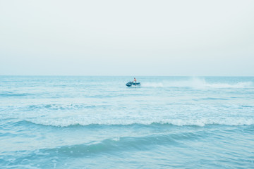 abstract blur jet ski with driver move on blue sea
