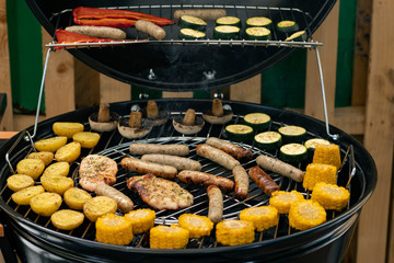 grill with potatoes, turkey meat, zucchini, mushrooms and sausages