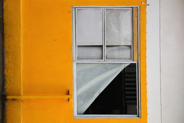 Abstract white and yellow wall with glass window.