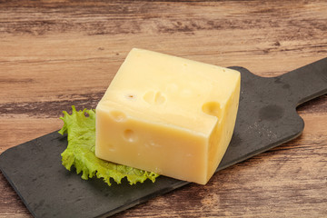 Emmental cheese over wooden board