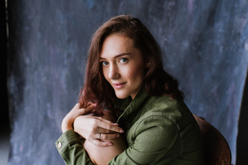 Portrait of a young woman in underwear and in a denim jacket in the studio.