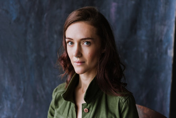 Fototapeta premium Closeup portrait of a young woman in a denim jacket in the studio.