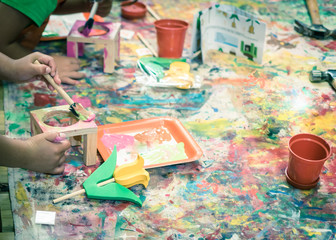 Kid hands painting craft at building workshop in local hardware store in Texas, USA