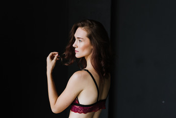 Portrait of a young woman in underwear in a studio.