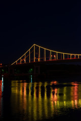 Fototapeta na wymiar Night view of pedestrian bridge on Dnipro in Kiev Ukraine