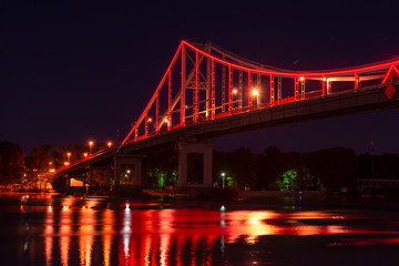 Fototapeta na wymiar Night view of pedestrian bridge on Dnipro in Kiev Ukraine