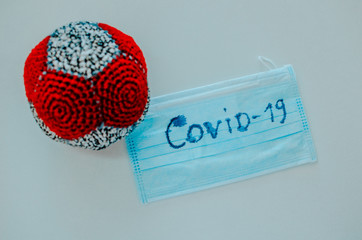model Coronavirus, medical protective mask, gloves, antiseptic on white background. SARS-cov-2...