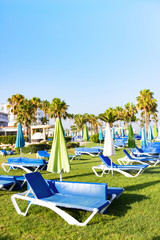 Mediterranean beach with empty sunbeds and umbrella in morning, Paphos, Cyprus. Concept of crisis of tourism business in pandemic. Lack of tourists
