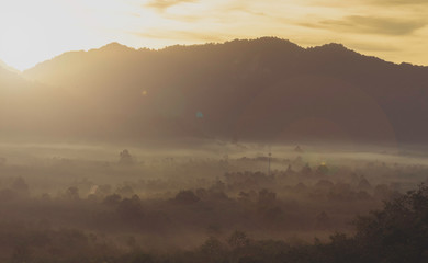 fog covered mountain and sunrise