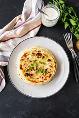 Chinese green onion pancakes on a black background. Stack of fried green onion pancakes. Dark photo