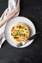 Chinese green onion pancakes on a black background. Stack of fried green onion pancakes. Dark photo