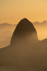 Silhouette of Sugarloaf Mountain during stunning sunrise over Guanamara Bay in Rio de Janeiro