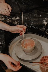 the manufacturing process in the pottery studio of a clay mug.