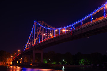 Fototapeta premium Night view of pedestrian bridge on Dnipro in Kiev Ukraine
