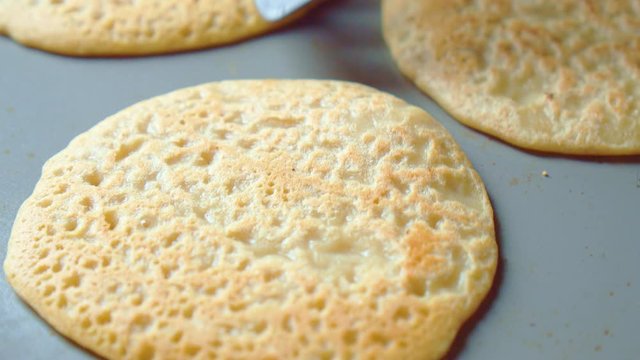 Three flapjack, tortilla, pancakes, bake in fry pan. Cooking shovel. Close up.