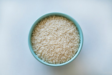 Uncooked rice in a blue bowl
