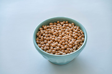 Raw chickpeas in a blue bowl