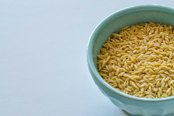 Raw Orzo in a blue bowl
