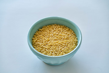 Raw Orzo in a blue bowl