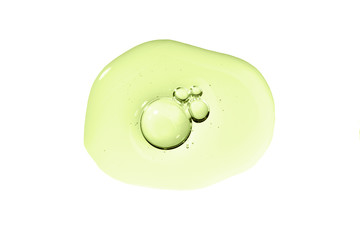 Skin care gel transparent sample green drop with bubble isolated on white background. Serum smear smudge swatch with collagen and peptides. Emulsion texture. Anti aging woman beauty cosmetic product.