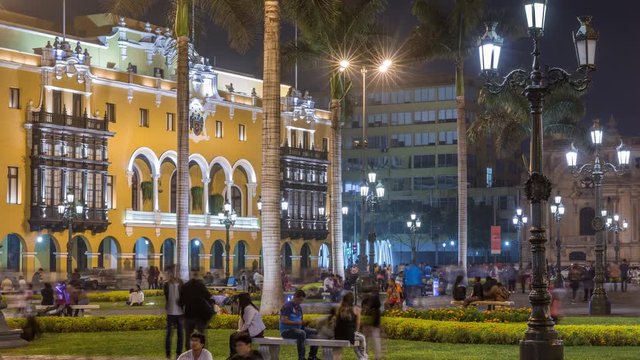 The Plaza de Armas with fountain night timelapse , also known as the Plaza Mayor, sits at the heart of Lima's historic center. Illuminated Municipal Art Gallery on a background
