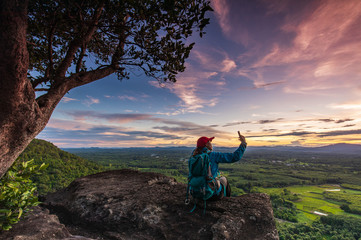 Fototapeta na wymiar Young woman hiking on Mountain, Pha Daeng viewpoint, Na Yung Nam Som National park, Udonthani province , Thailand.