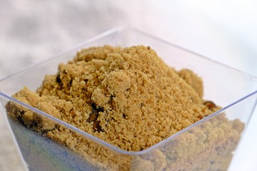 Organic soft brown sugar in a glass.