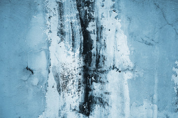 Dirty blue wall with abstract pattern and black smudges. 
