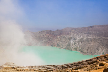View from above, stunning view of the Ijen volcano with the turquoise-coloured acidic crater lake. The Ijen volcano complex is a group of composite volcanoes located in East Java, Indonesia.