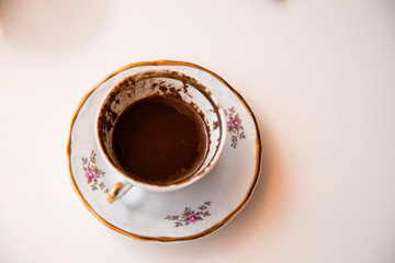 A cup of Turkish coffee, traditionally using for fortune telling. traditional porcelain turkish coffee cup. white background