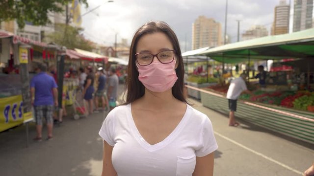 Pandemic, portrait of a young tourist woman wearing protective mask on street crowd people. the concept health and safety, N1H1 coronavirus quarantine, virus protection
