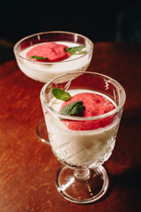 Stock Photo - Dessert panna cotta with fresh berries on a dark background
