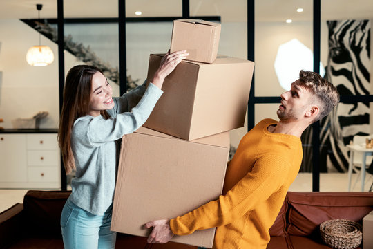 Young adult newlyweds move in new accommodation together
