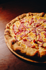 Stock Photo - Fresh delicious Italian pizza  on a dark background