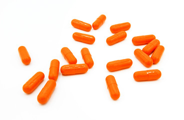 Many orange capsules or pills isolated on white background. Herb food, Vitamin and Medical concept. Group of object and Selective focus technique