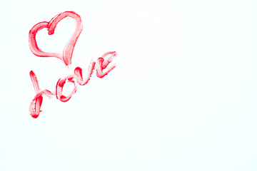 on a white background in the upper left corner the word love is written in red lip gloss and a heart is drawn