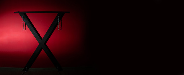  Horizontal panorama banner for web and text design. SM cross or Andreaskreuz is used in the BDSM scene on red background