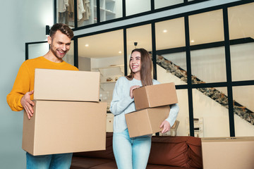 Young adult newlyweds move in new house together
