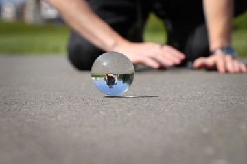 Frolicsome with brother and lens ball on the path in Greenwich park, London, United kingdom. Glass...