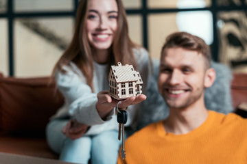 Young adult couple move in new house together