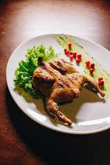 Stock Photo - Grilled fried roast Chicken Tabaka on a white plate