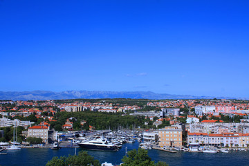 Fototapeta premium City on the Adriatic Sea, luxurious apartment buildings near the water, promenade, main bridge Zadar, Croatia. A tourist place, a beautiful and clean city in Europe.Photography for tourism advertising