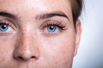 A close up of a person with blue eyes looking at the camera - Powered by Adobe
